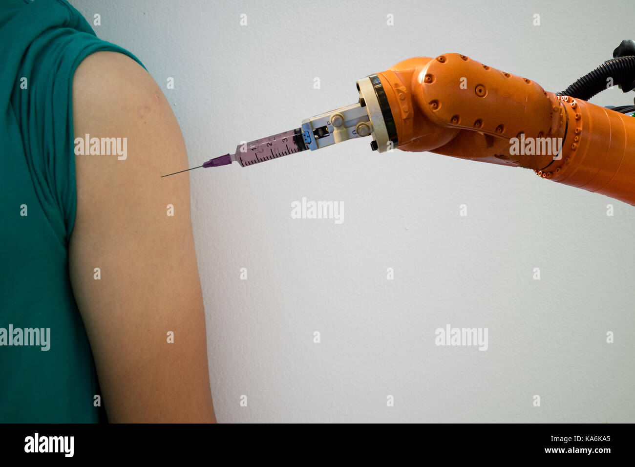 smart robotic in medical concept, doctor robot try to inject the medicine on upper arm of the patient ,it help to faster recovery time,precising area, Stock Photo