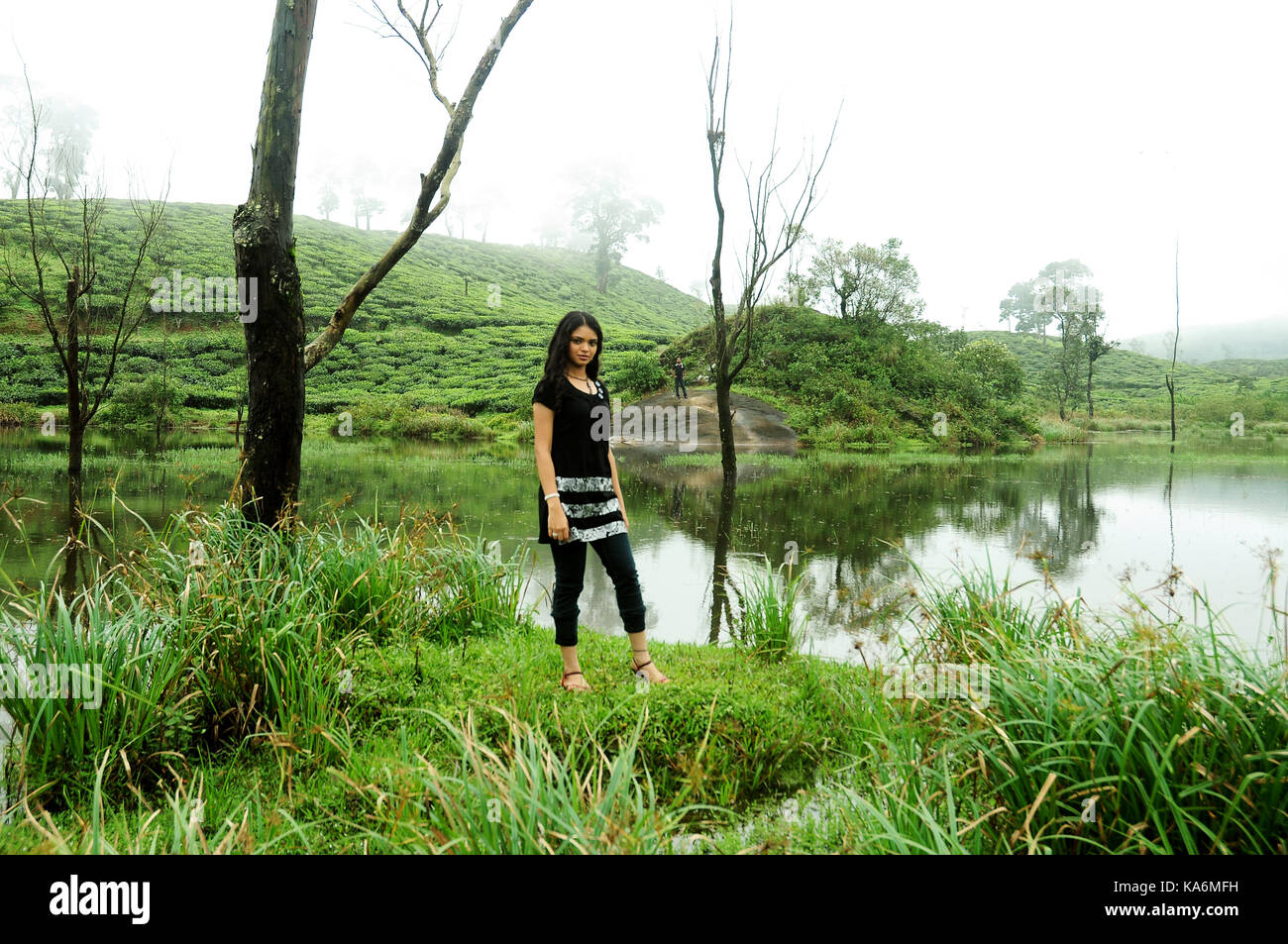 Portrait of beautiful smiling woman posing near the river Stock Photo ...