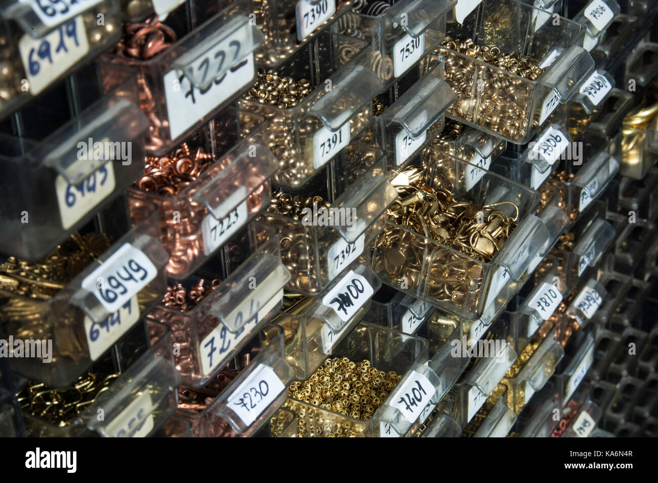 Small jewellery components in factory sampling store. Stock Photo