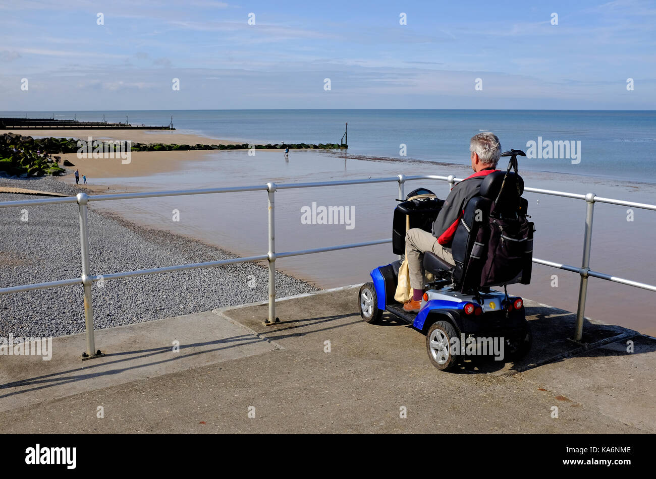 man sitting on mobility scooter, sheringham, north norfolk, england Stock Photo Alamy