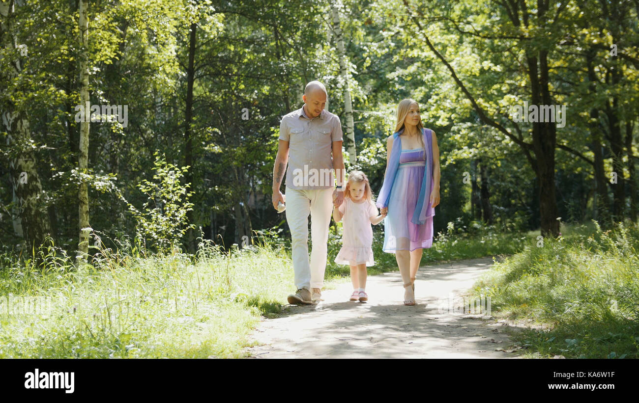 Happy family walking in the park at sunny day Stock Photo - Alamy