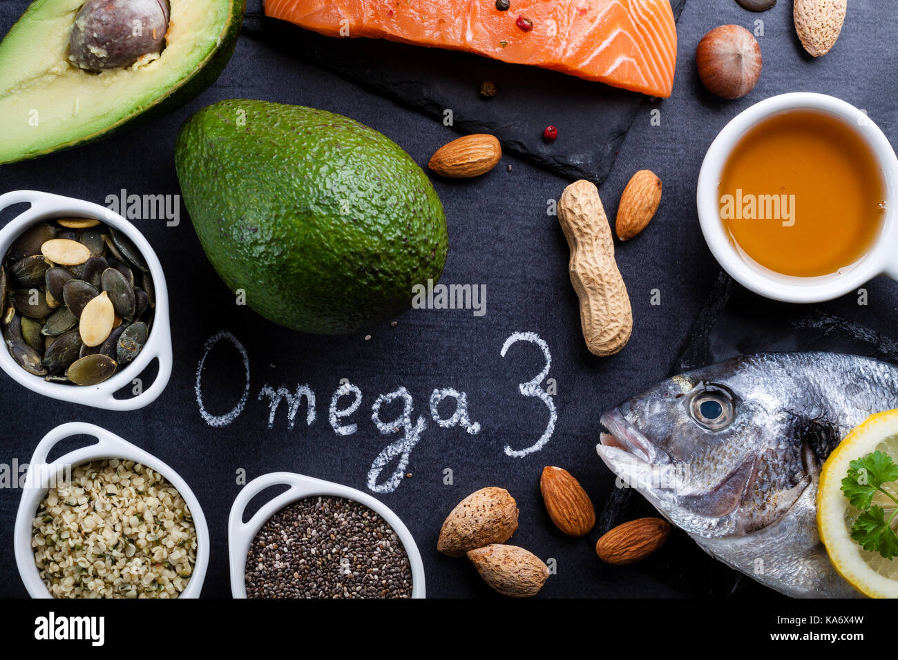 Black slate table with product rich in omega 3 and vitamin D. Written