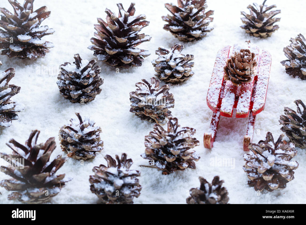 Christmas decoration, view from above for cone and sleigh frosted by snow. Stock Photo