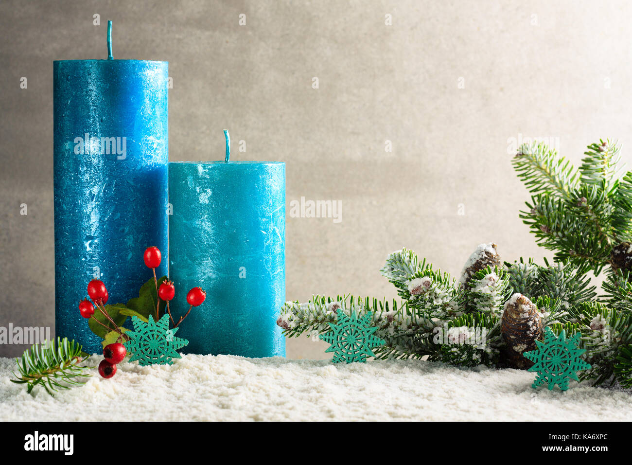 Christmas decoration with green twig and blue candles with copy space. Stock Photo