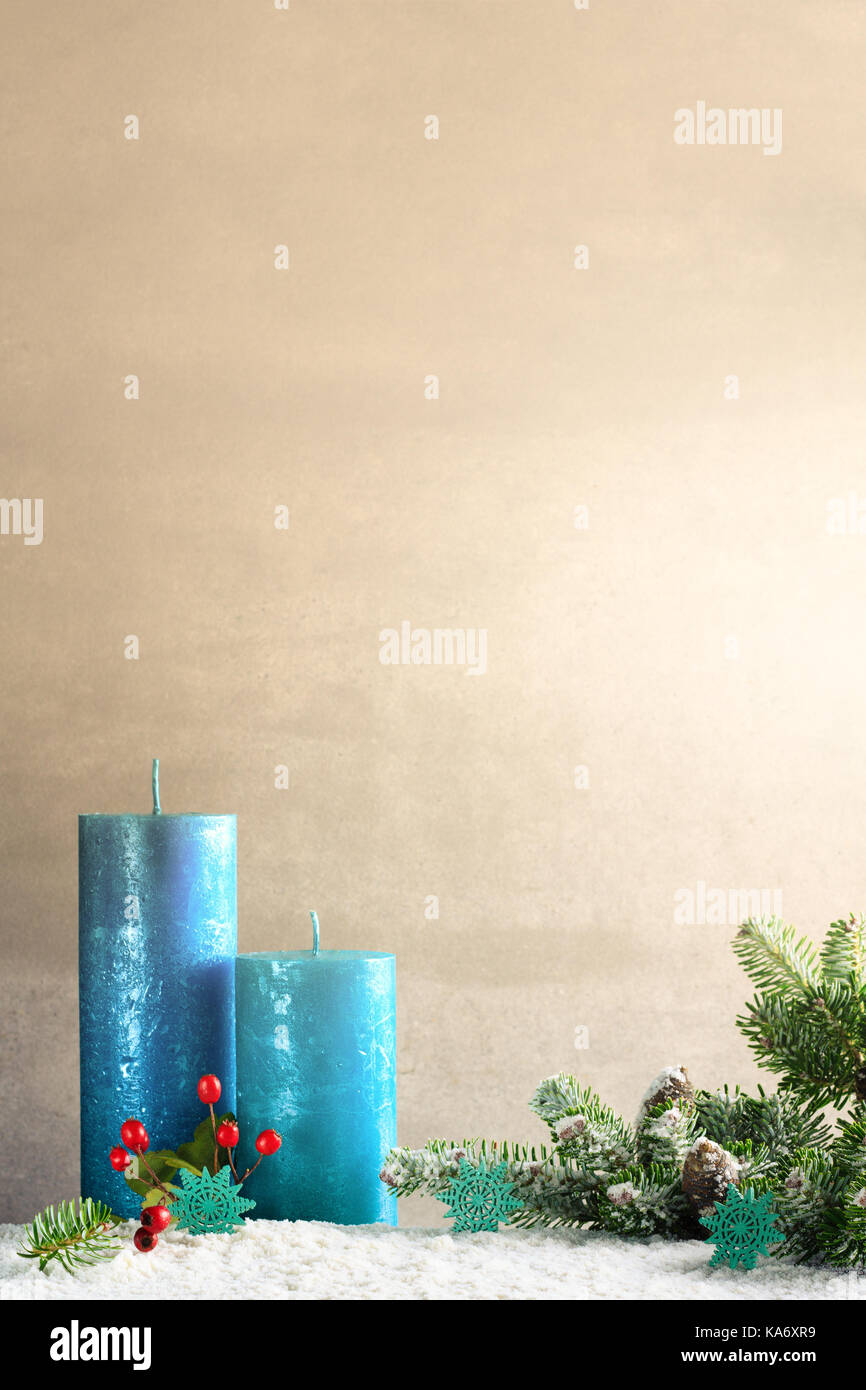 Christmas decoration with green twig and blue candles with copy space. Stock Photo