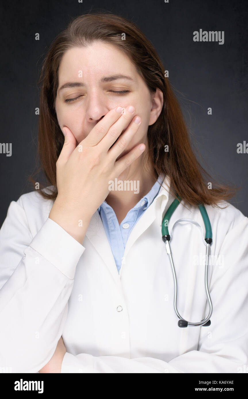 Portrait of a tired, yawning female doctor Stock Photo Alamy