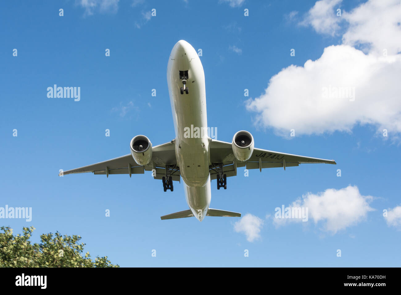 Low flying jet aircraft descending towards Heathrow Airport, Terminal 4, in Hounslow, Middlesex, UK. Stock Photo