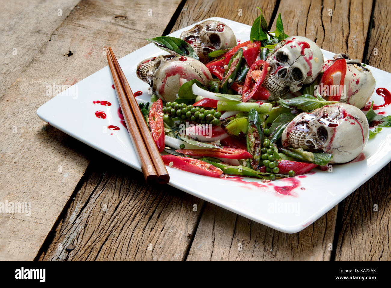 Spicy salad skulls with chili and blood for halloween night Stock Photo -  Alamy