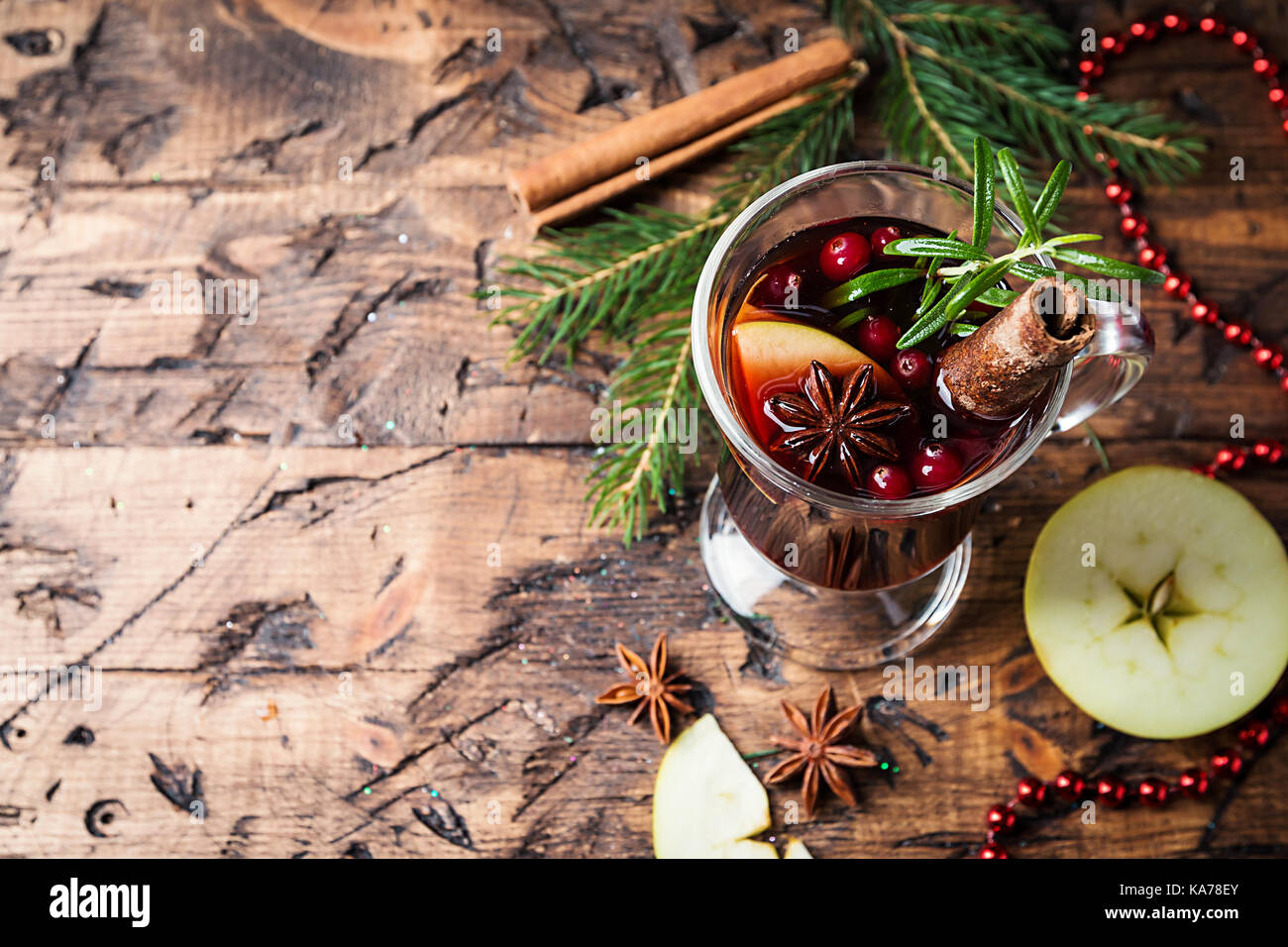 christmas hot mulled wine in a glass mug with cinnamon, cardamom and