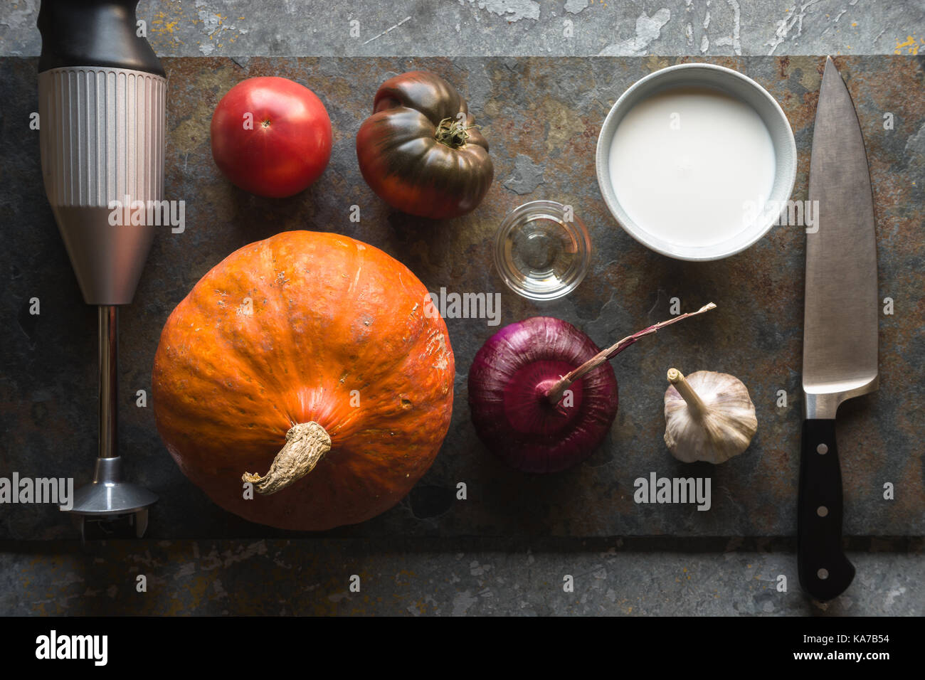 Pumpkin, red onion, garlic and a blender for making pumpkin soup horizontal Stock Photo