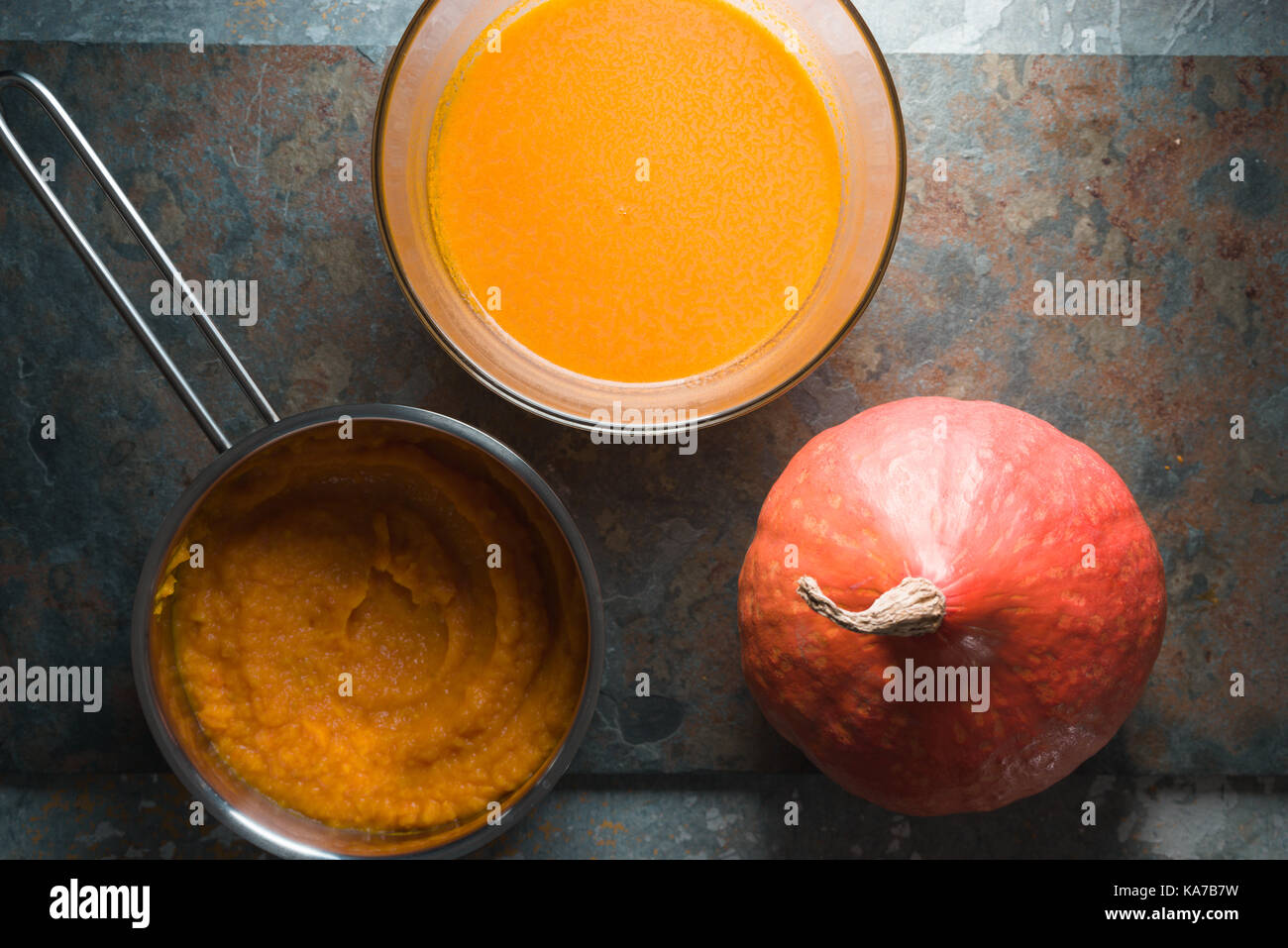 Pumpkin, pumpkin soup bowl and pumpkin puree in a saucepan horizontal Stock Photo