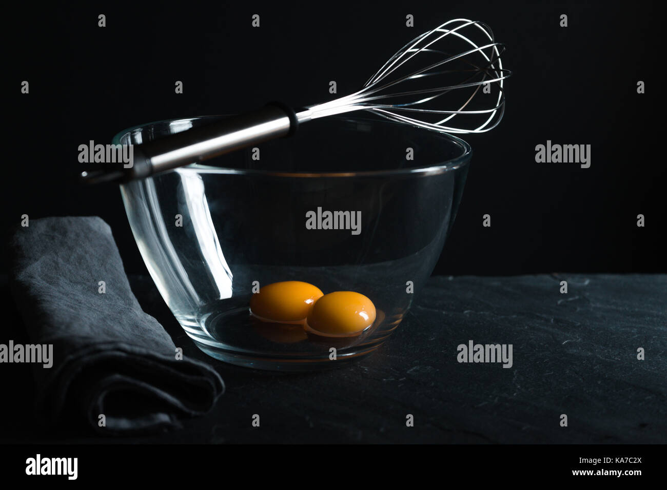 Chicken yolks in a glass bowl and whisk for whipping horizontal Stock Photo