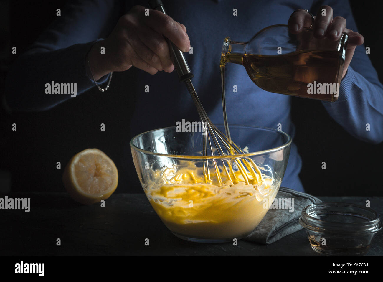 Beat egg yolks with mustard and olive oil horizontal Stock Photo