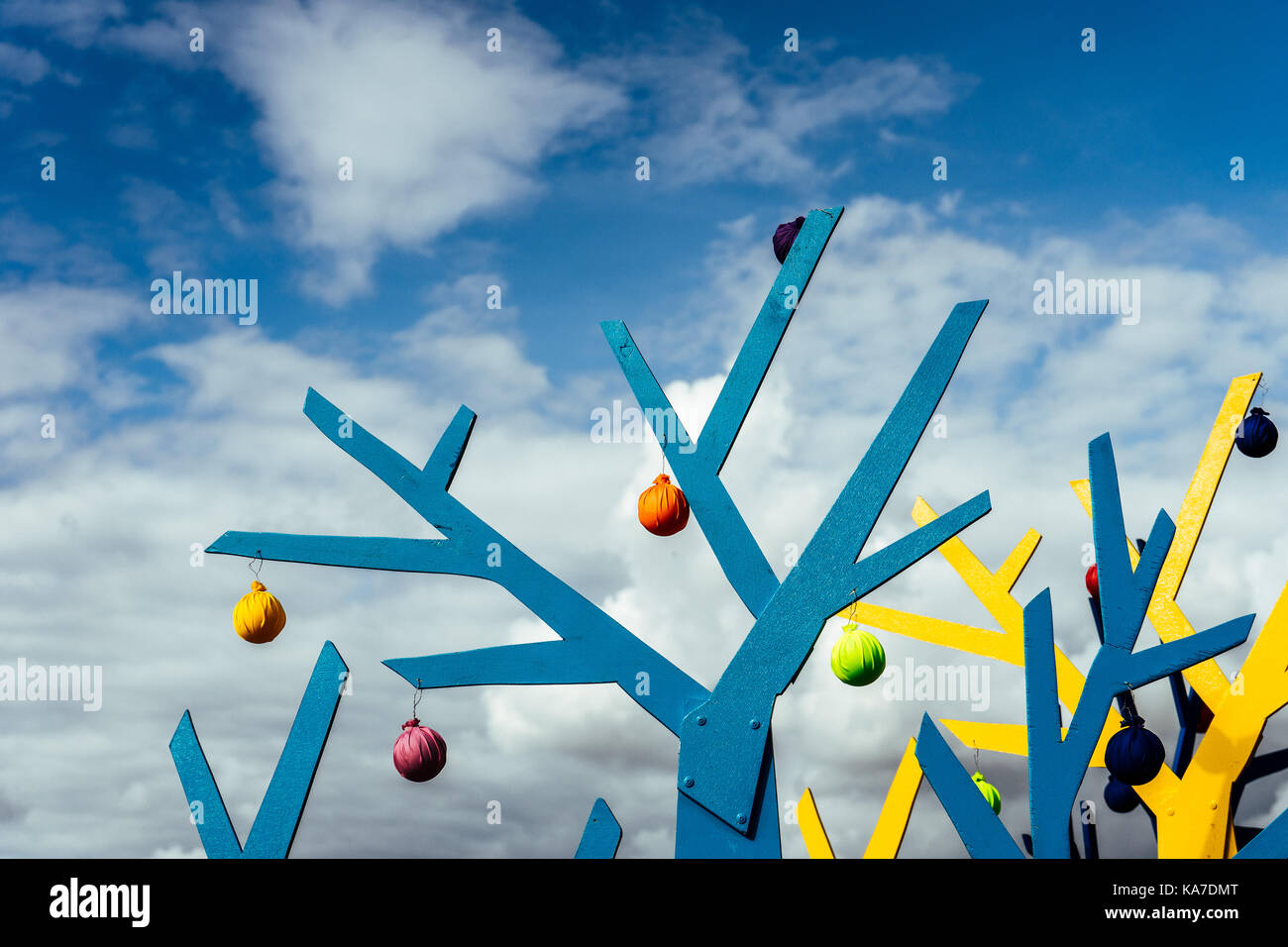 Abstract tree shapes against a blue sky with clouds horizontal Stock Photo