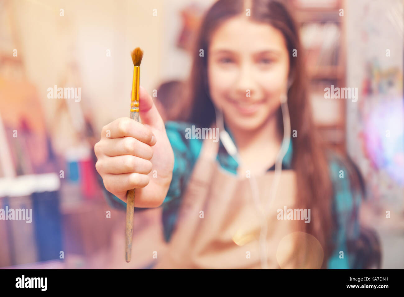 Smiling girl posing with painting brush for camera Stock Photo Alamy