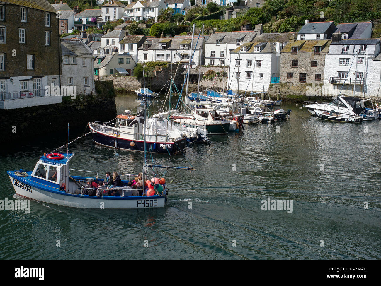 reflection of Polperro harbour in fish warehouse fork lift trucks Stock Photo