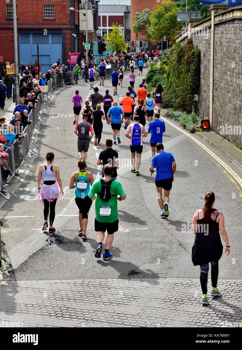Runners in Simplyhealth half marathon race with crowd watching in the city centre of Bristol, UK