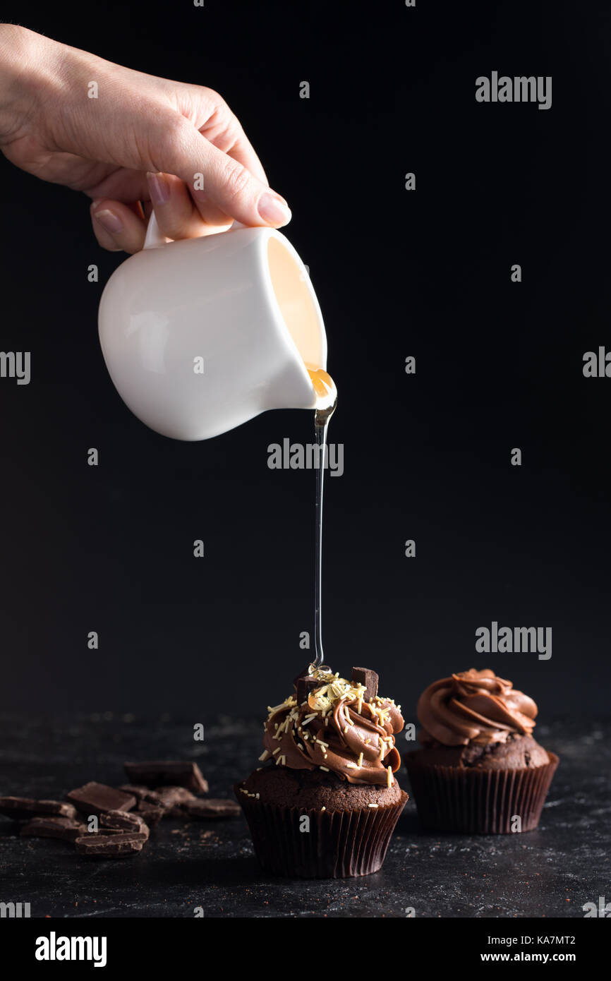 pouring syrup on cupcake Stock Photo Alamy