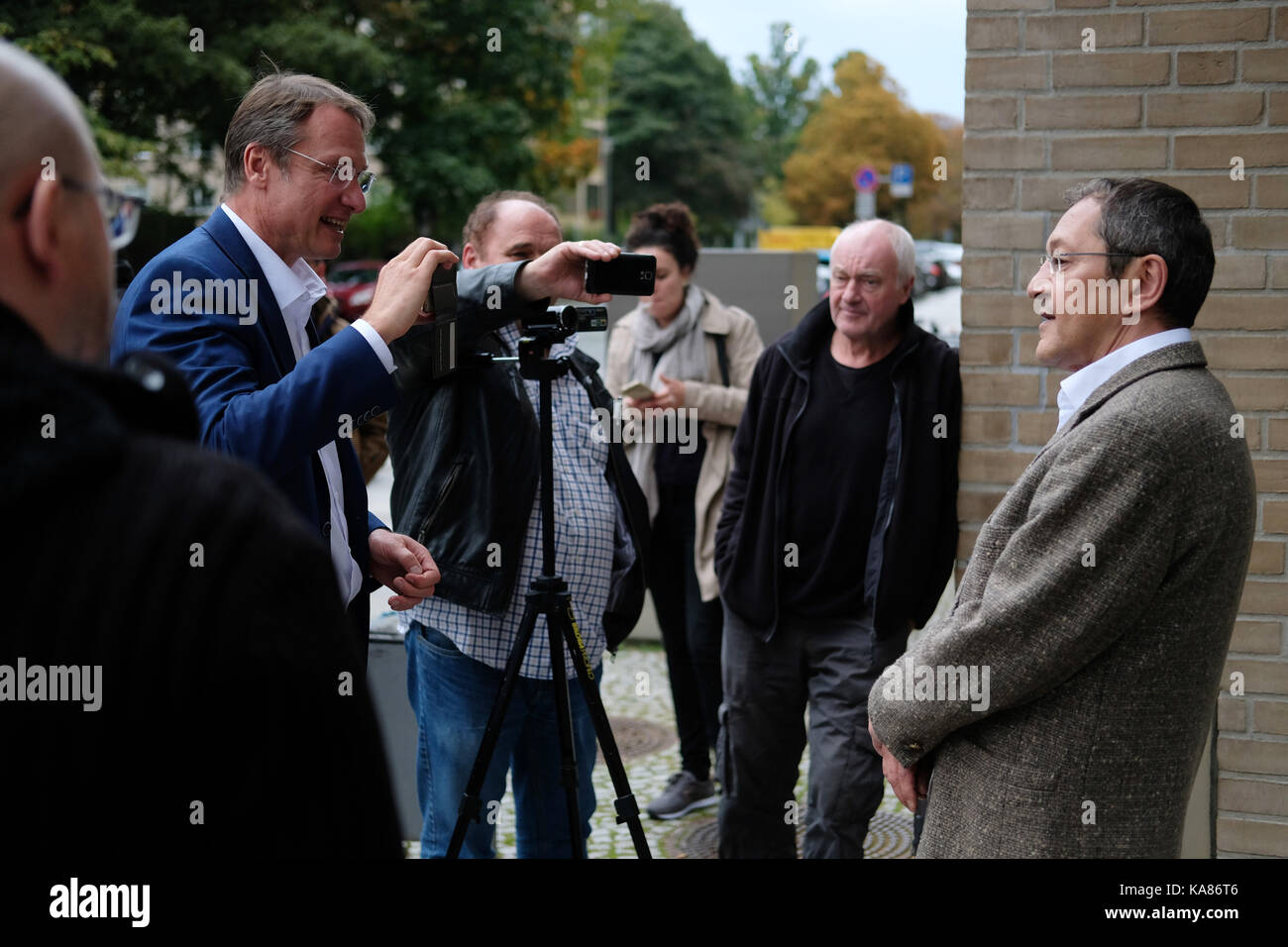 German-turkish author Akif Pirincci (R) speaks to journalists outside the district court in Dresden, Germany, 25 September 2017. Pirincci was sentenced to pay a 11,700 Euro fine following a hate speech at an event of the islamophobic movement 'Pegida', but filed an objection. Photo: Sebastian Willnow/dpa-Zentralbild/dpa Stock Photo