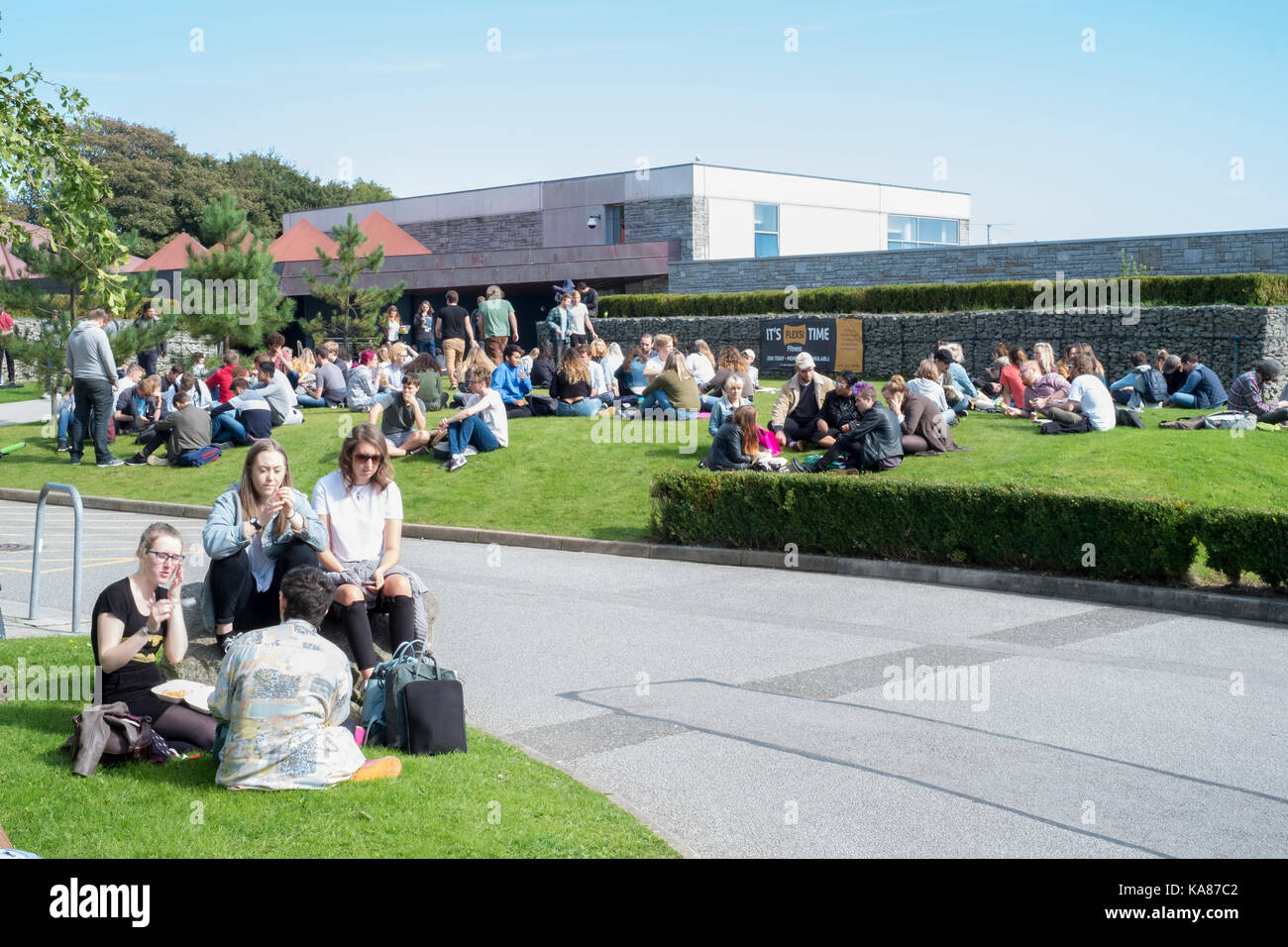 Cornwall, UK. 25th Sep, 2017. UK Weather. Students converge on the green areas of Falmouth University's Tremough Campus at lunch time to enjoy the sunshine as a new academic year gets underway Credit: Mick Buston/Alamy Live News Stock Photo