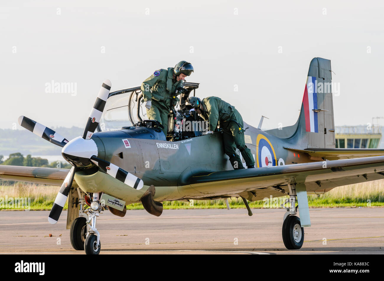 RAF Aldergrove, Northern Ireland. 25/09/2017 - Pilot and trainee disembark a Tucano training aircraft from 72 (R) Squadron as they land at RAF Aldergrove as part of their centenary celebrations.  One of the aircraft was painted in a specially designed commemorative livery from the Battle of Britain Spitfire. Stock Photo