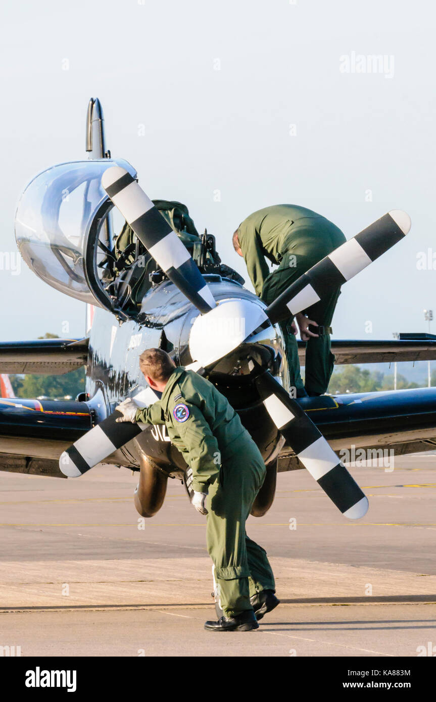 RAF Aldergrove, Northern Ireland. 25/09/2017 - Pilot checks his Tucano training aircraft after he lands at RAF Aldergrove as part of their centenary celebrations.  One of the aircraft was painted in a specially designed commemorative livery from the Battle of Britain Spitfire. Stock Photo