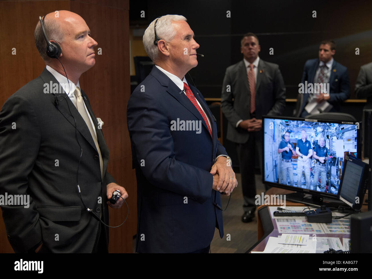 United States Vice President Mike Pence, right, and US Representative Robert Aderholt (Republican of Alabama), talk with Expedition 53 crew members Joe Acaba, screen left, Randy Bresnik, screen center, and Mark Vande Hei onboard the International Space Station from the Payload Operations Integration Center (POIC) of the NASA Marshall Space Flight Center, Monday, Sept. 25, 2017 in Huntsville, Alabama. The Vice President visited the space center to view test hardware for NASA's Space Launch System, America's new deep space rocket and to call the crew onboard the International Space Station. Ma Stock Photo