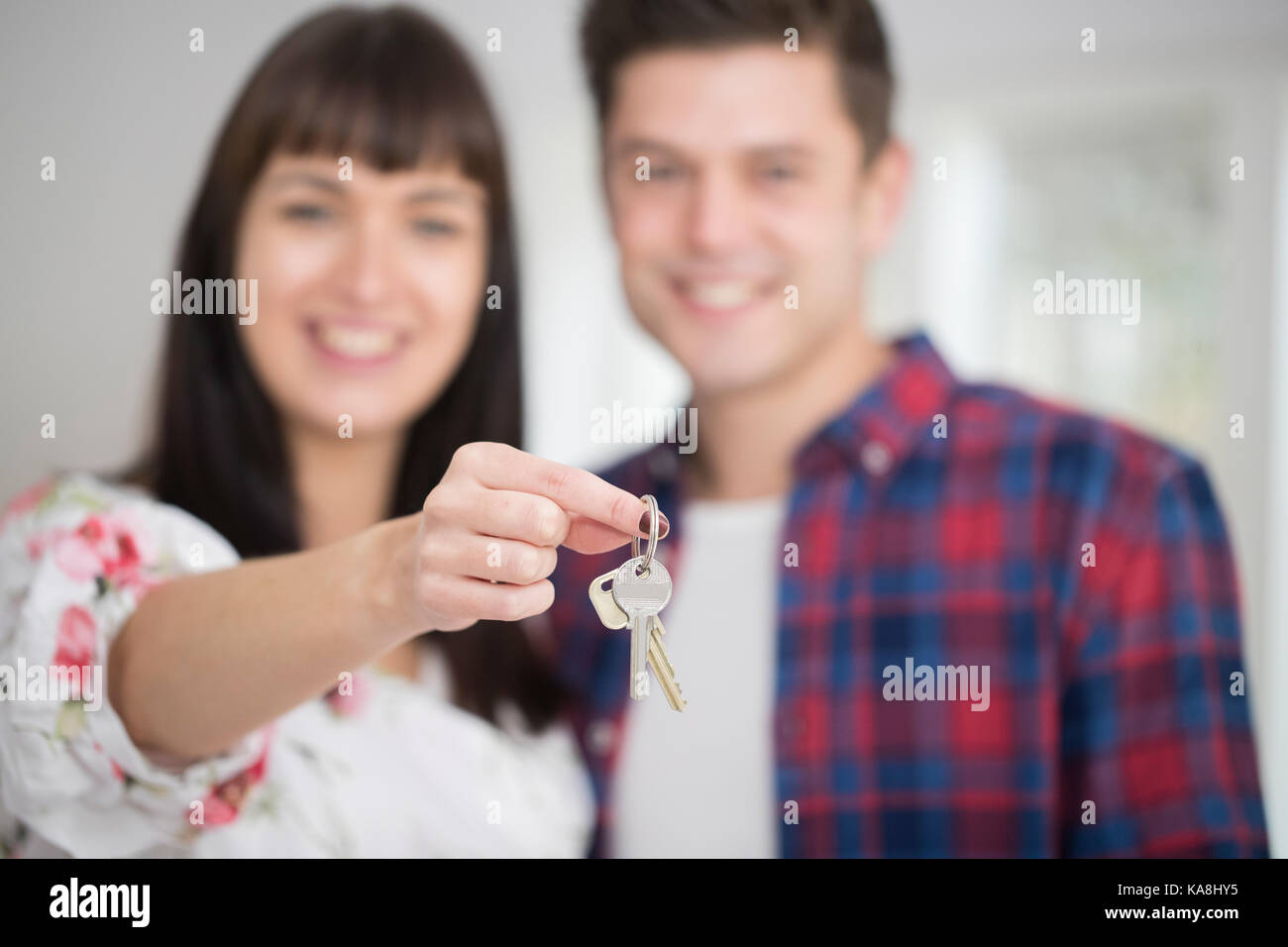 Portrait Of Young Couple Holding Keys To New Home Stock Photo