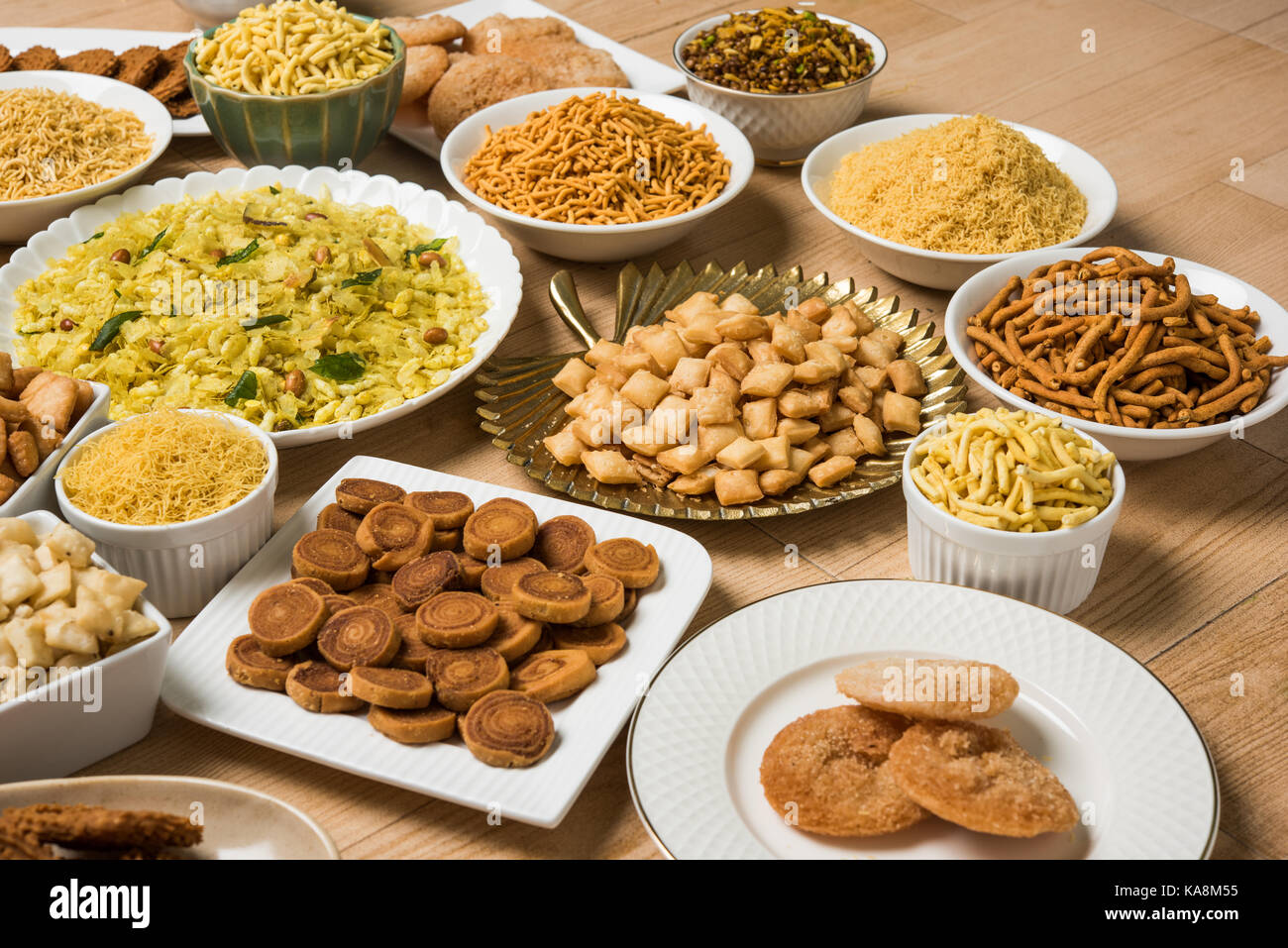 stock photo of  Diwali food or Diwali snacks or Diwali sweets like anarsa, bakarvadi, chakli, sev, bhujiya, shankar pale and chivda or chiwada, karanj Stock Photo