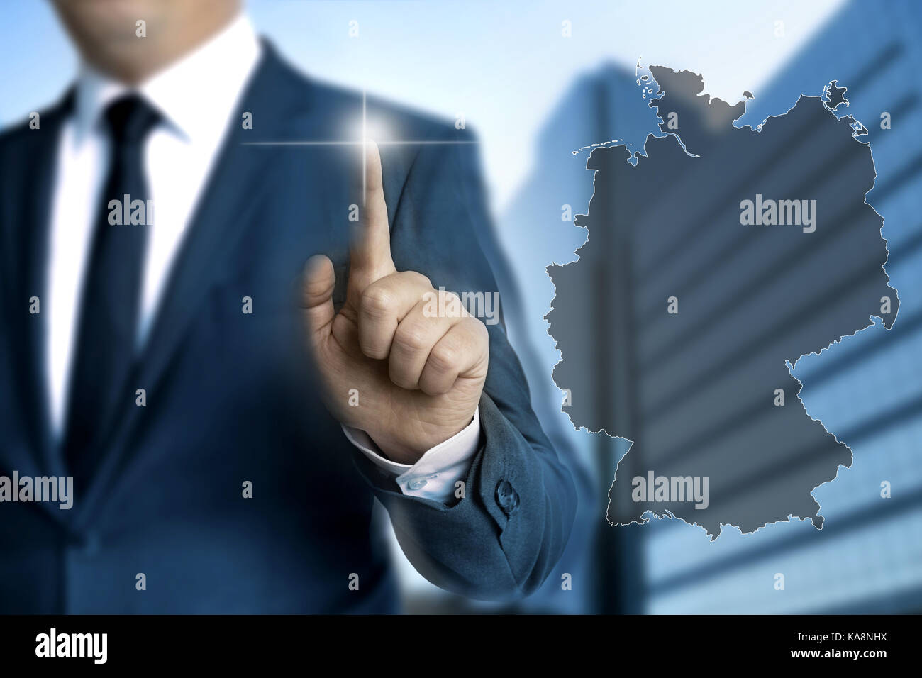 Germany map touchscreen is operated by businessmen. Stock Photo