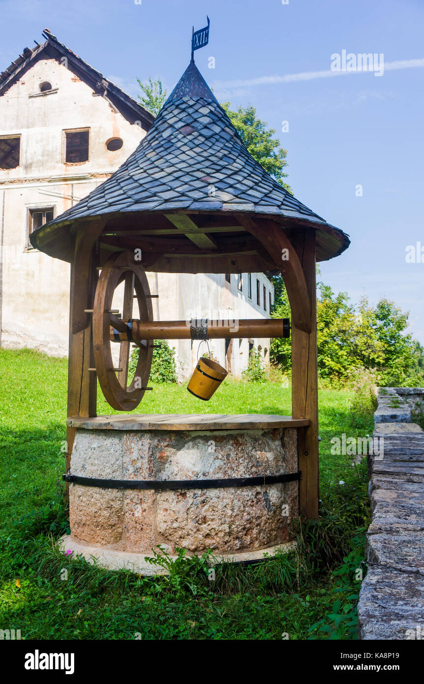 Old style stone well with roof. Stock Photo