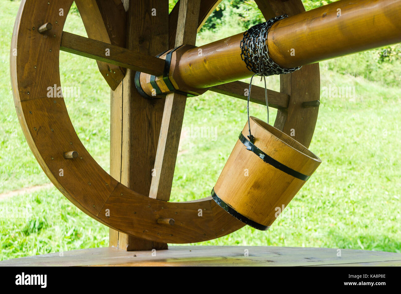 Old style wooden bucket on old well. Stock Photo