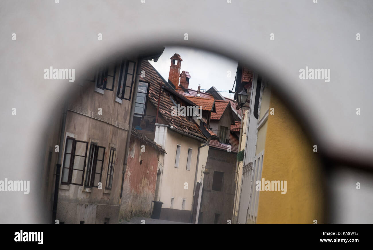 Reflection of street with old buildings in the car mirror. Stock Photo