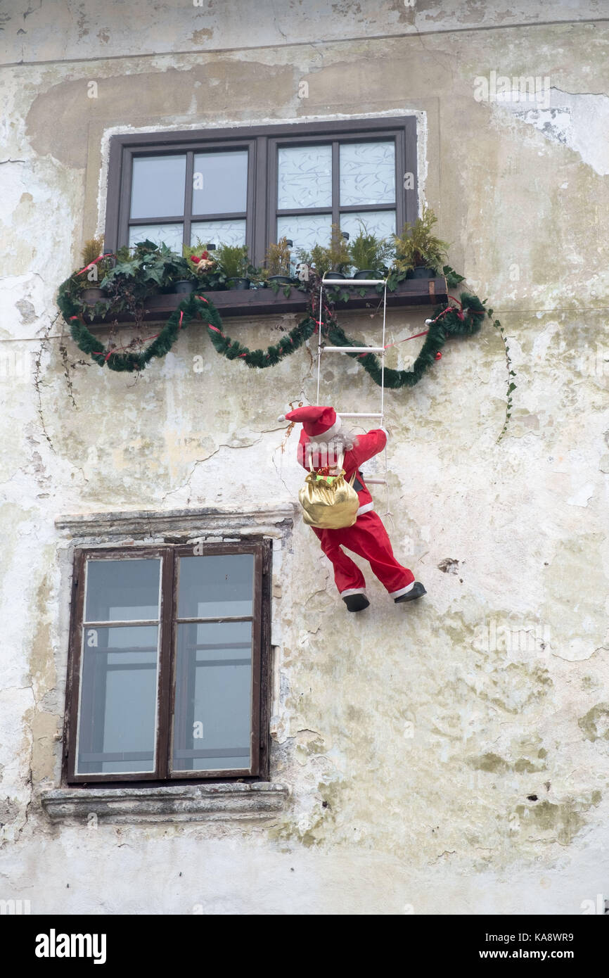 Santa Climbing Up To A Window Stock Photo