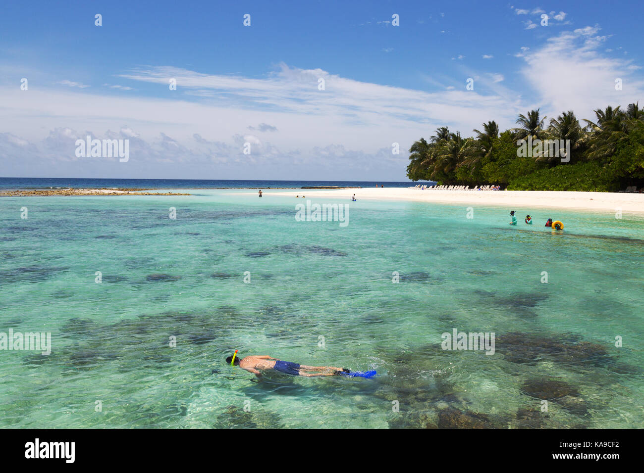 Maldives snorkeling - tourists on a Maldives holiday snorkeling off Kuramathi resort, the Maldives, Asia Stock Photo