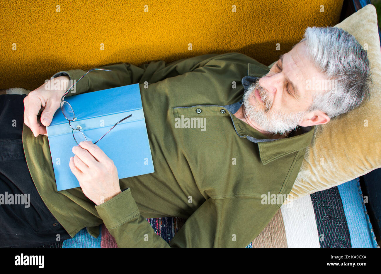 Senior man sleeping with book on a bed in the backyard Stock Photo - Alamy