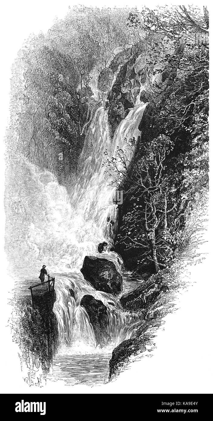 1870: Visitor admiring Stock Ghyll Force, a spectacular 70 foot waterfall on a tributary of the River Rothay, that  tumbles down through a series of waterfalls to the centre of Ambleside, on Lake Windermere, the Lake District, Cumbria, England Stock Photo