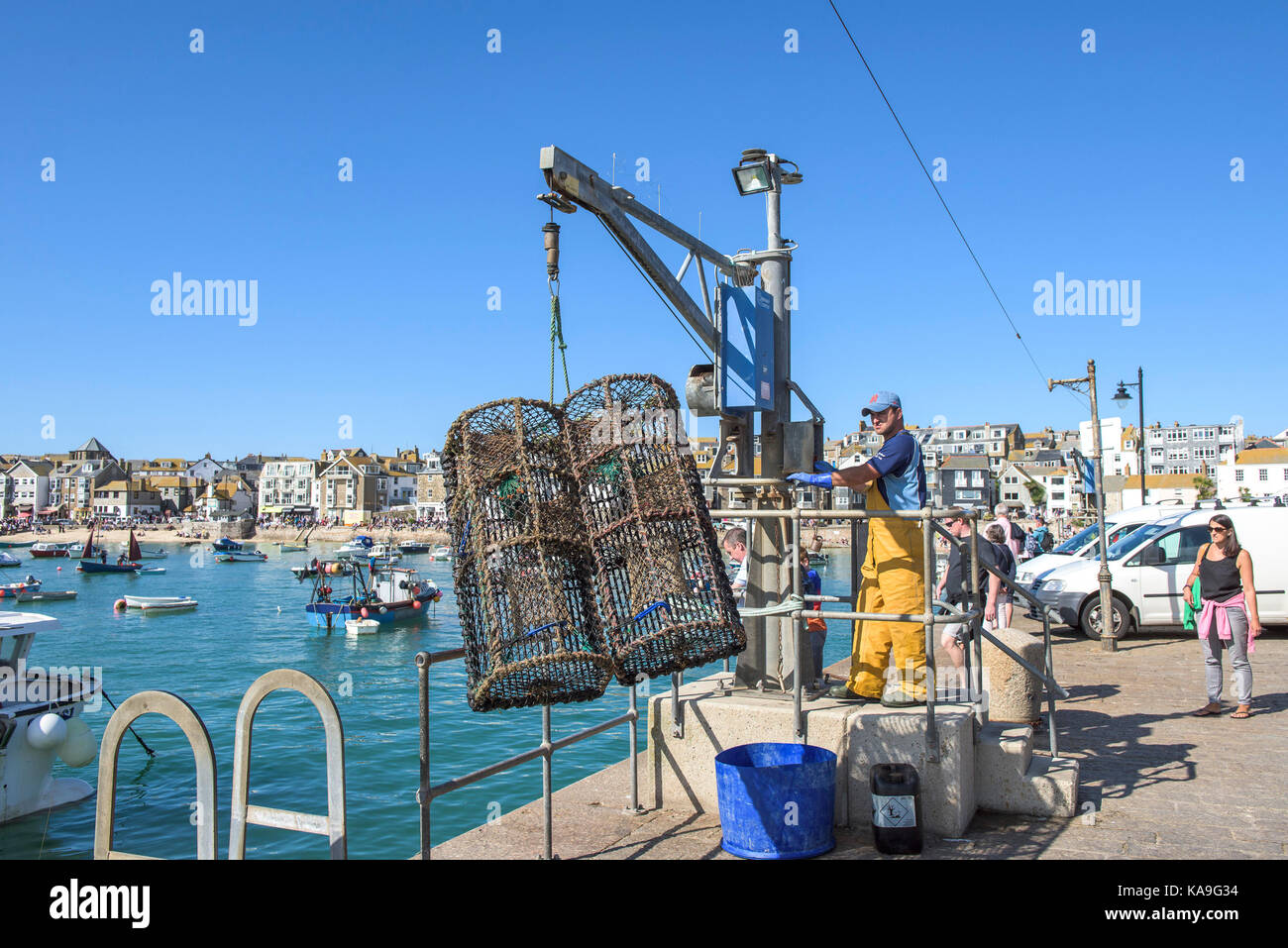 St Ives fishing industry a fisherman using a hoist to unload crab