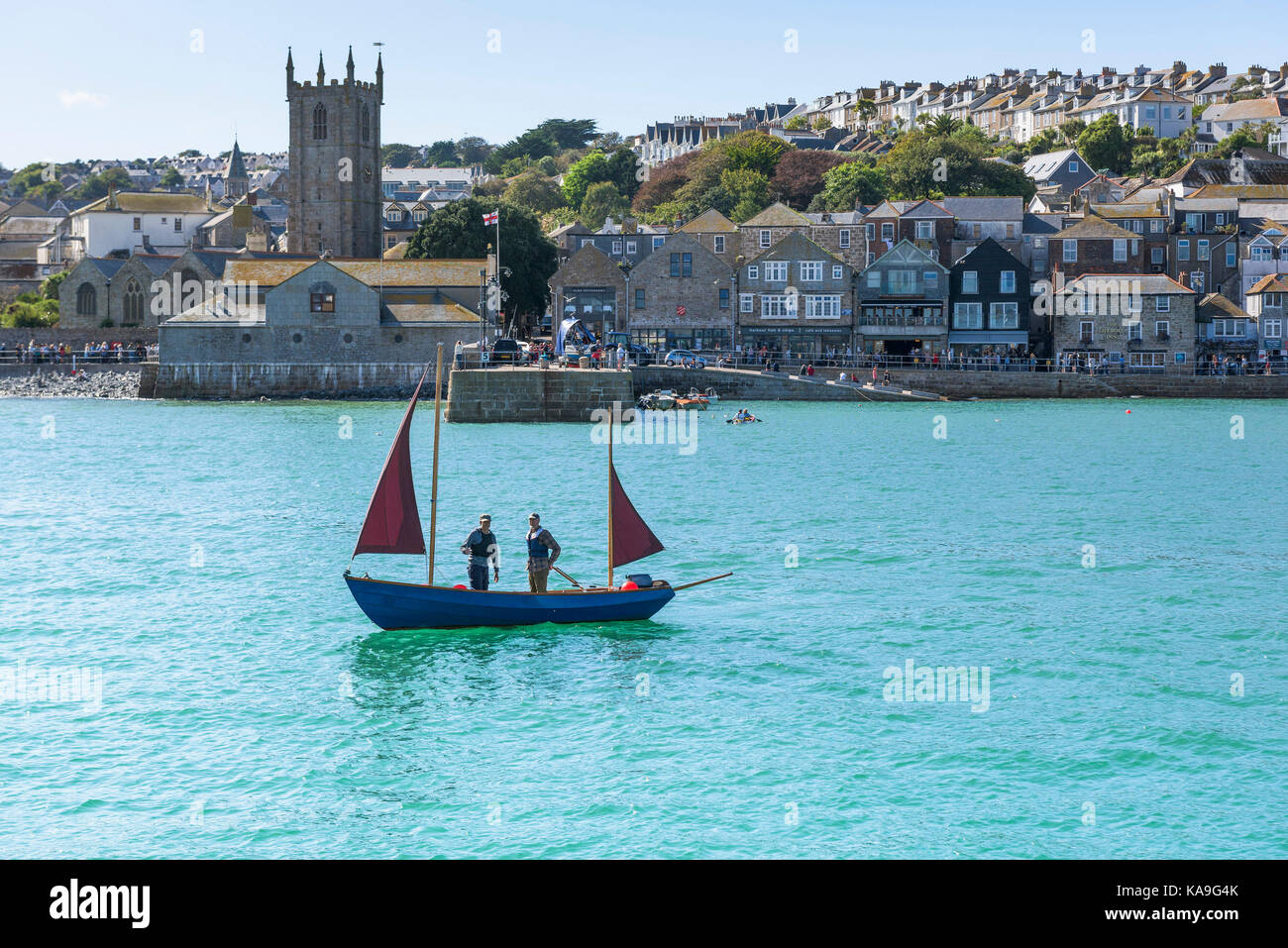 St Ives - a small ketch sailing in St Ives Harbour in St Ives in Cornwall. Stock Photo