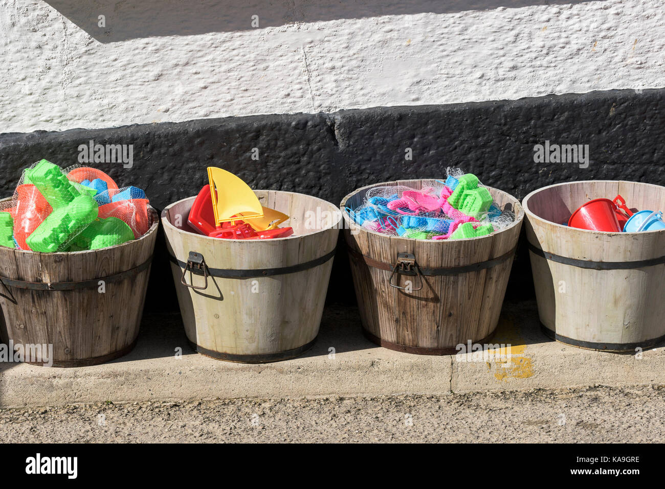 Wooden tubs of colourful plastic beach toys. Stock Photo