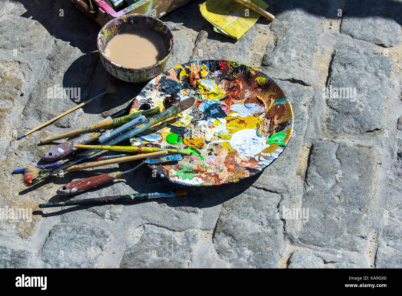 Acrylic paint - a plate used as an artists palette outdoors. Stock Photo