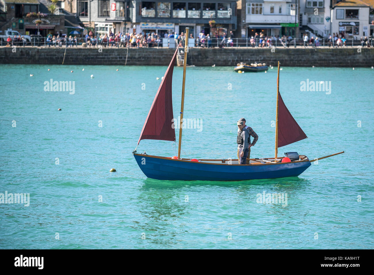 St Ives - a small ketch sailing in St Ives Harbour in St Ives in Cornwall. Stock Photo