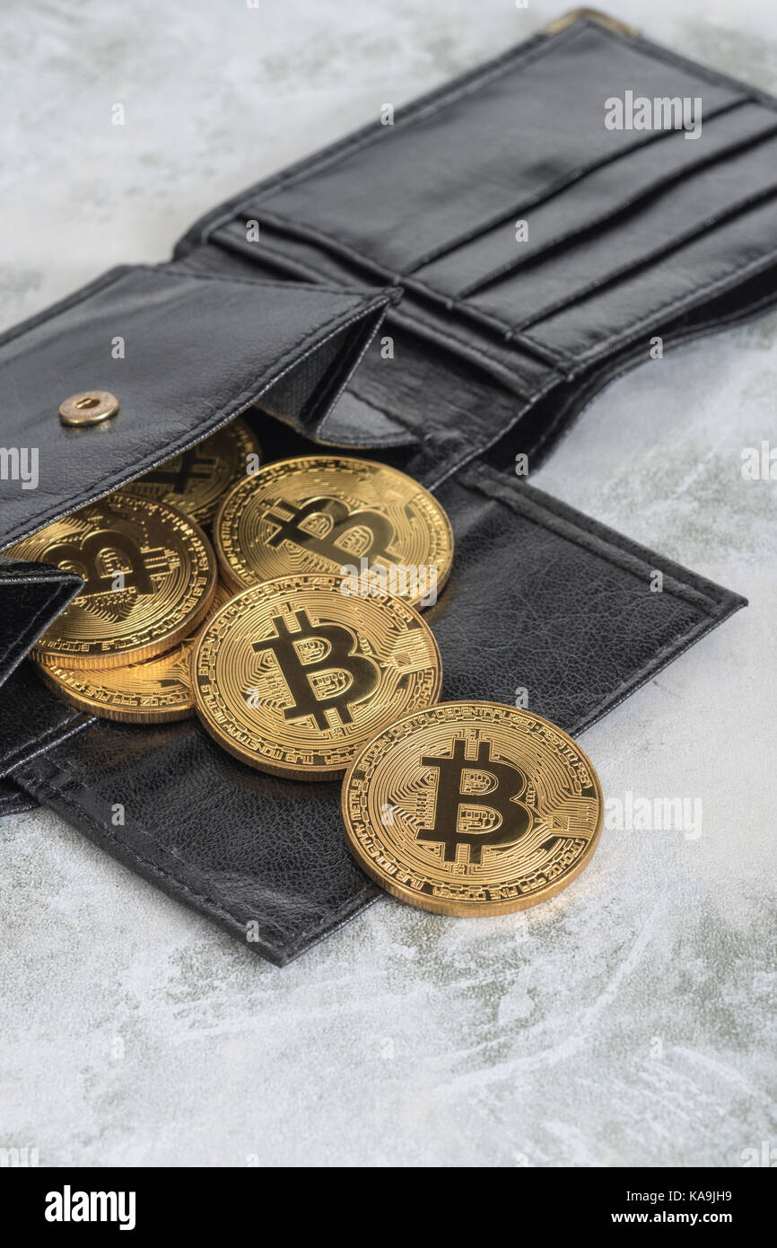 Gold Bitcoins spilling from black billfold wallet. For Bitcoin wallet,  virtual money, cryptocurrency, peer to peer transactions, Bitcoin price  crash Stock Photo - Alamy
