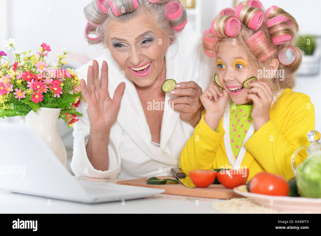 Senior woman and girl using laptop Stock Photo - Alamy