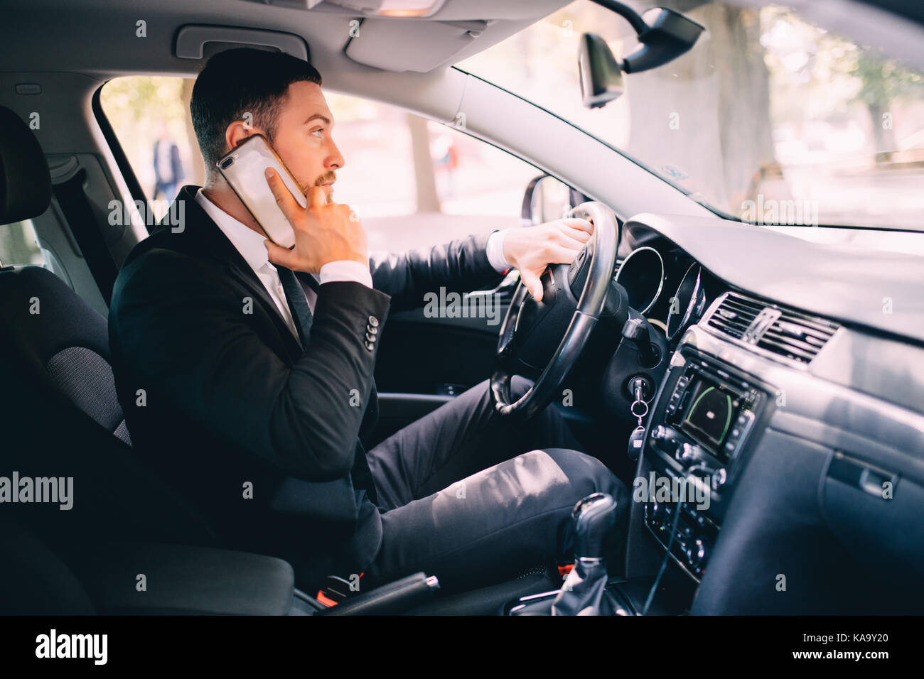 Business man driver speak phone white drive car Stock Photo Alamy
