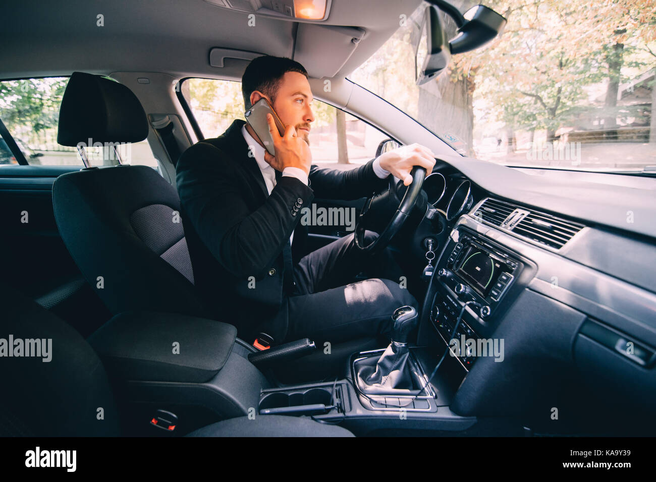 Business man driver speak phone white drive car Stock Photo Alamy