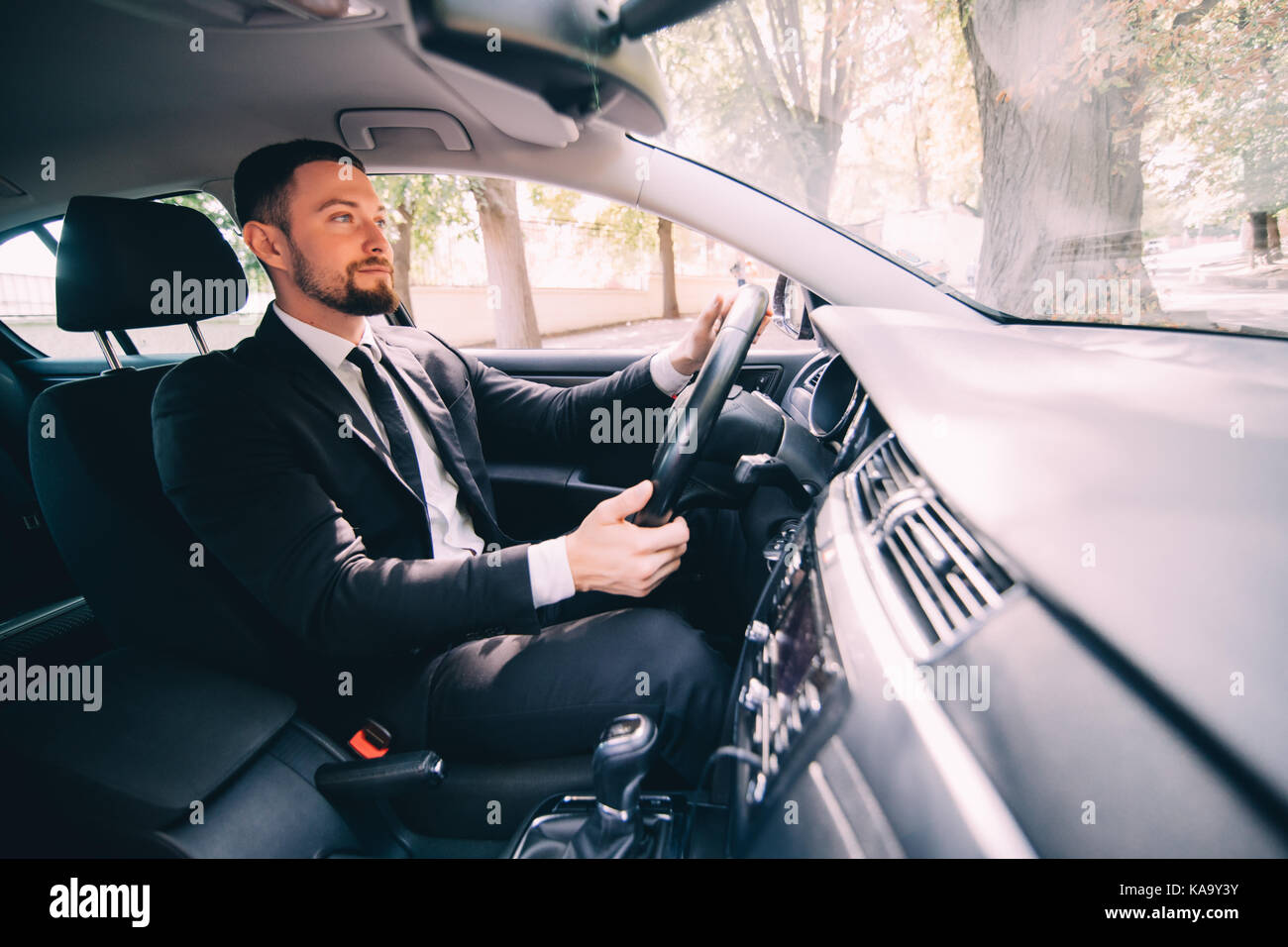 Young handsome Businessman driving a car on the street Stock Photo - Alamy