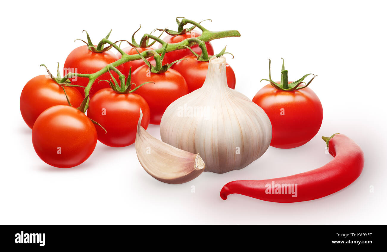 Branch of fresh red cherry tomatoes with green leaves, single tomato, garlic with clove and red chili pepper vegetables isolated on white background Stock Photo