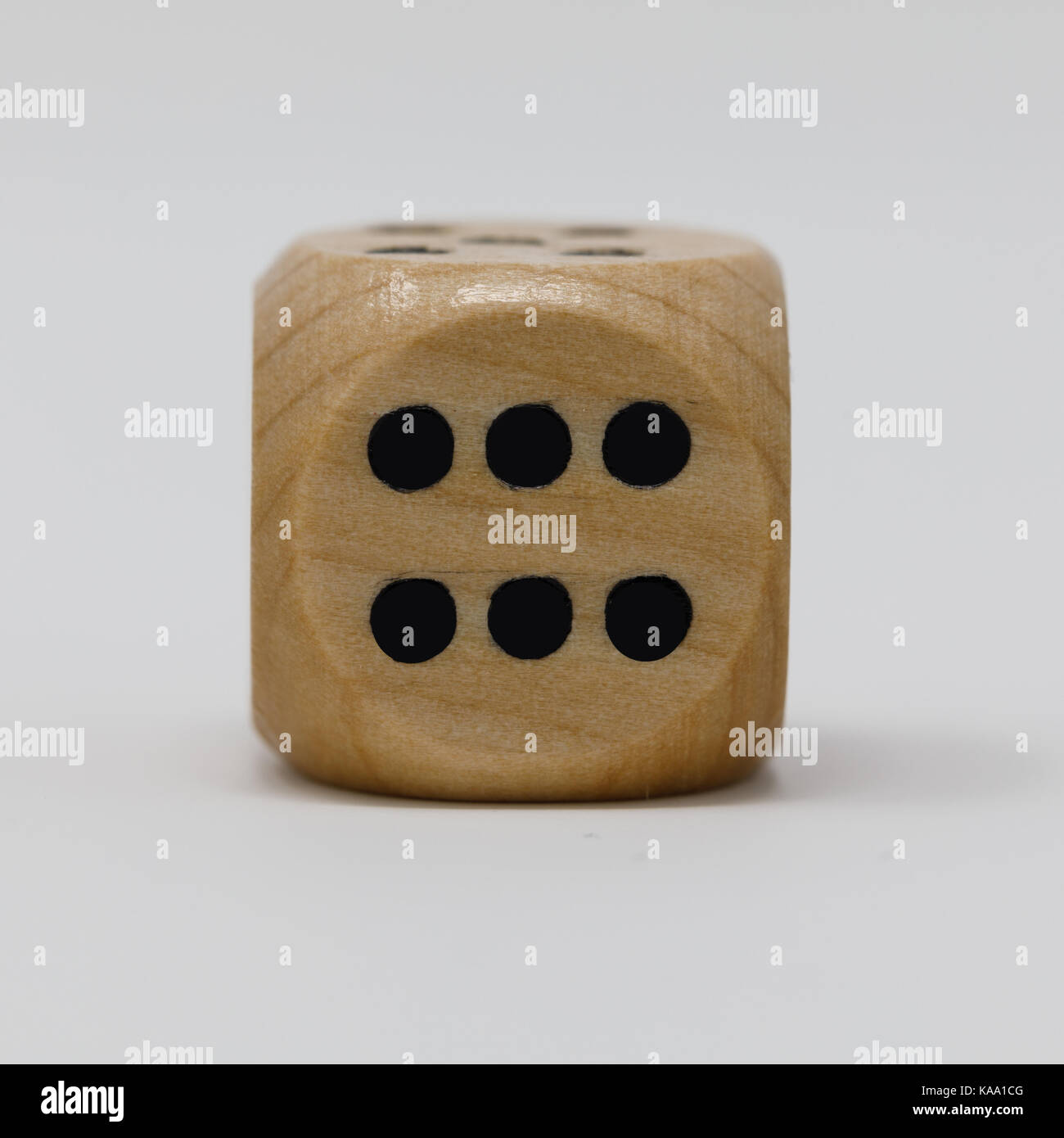 First in a sequence of real wooden dice 6 spot die Stock Photo Alamy