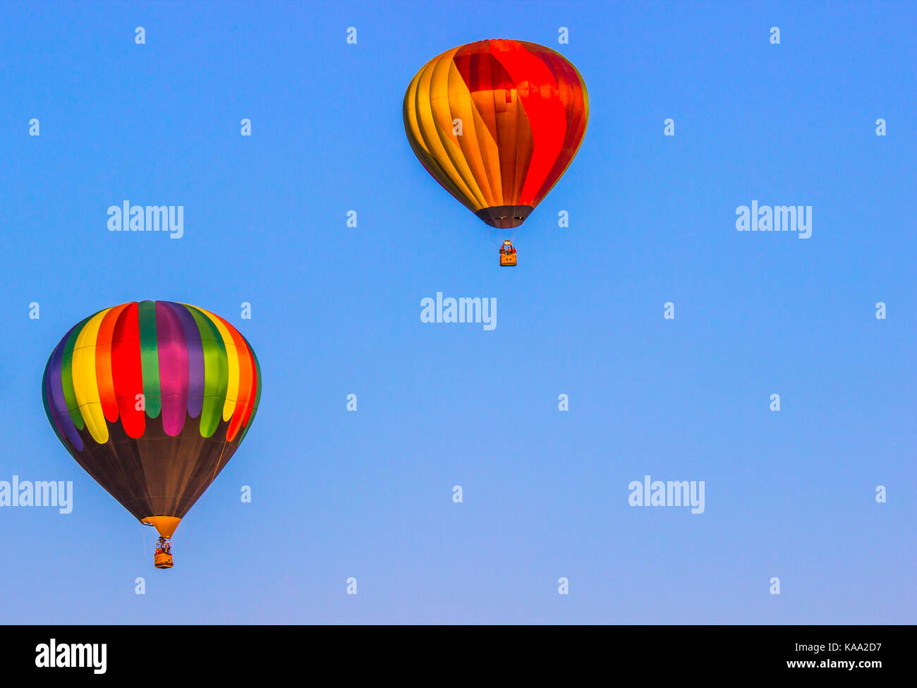 Two Hot Air Balloons Against Blue Sky Background Stock Photo - Alamy